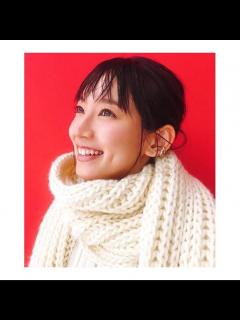 [x]a woman wearing a white scarf and smiling